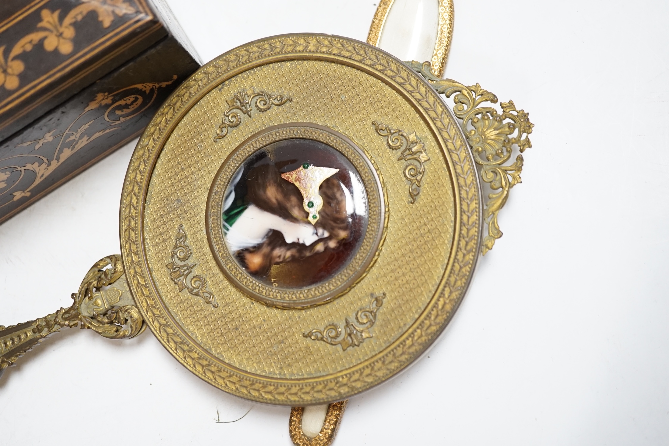 An inlaid Sorrento style box, a gilt hand mirror with enamel cartouche, a pair of brass candle holders and another hand mirror, box 30cm wide